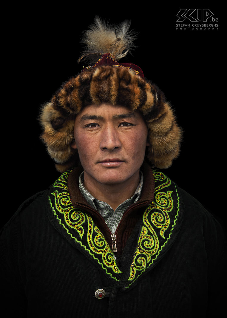Ulgii - Golden Eagle Festival - Berkutchi Portrait of a proud berkutchi, a Kazakh eagle hunter in western Mongolia. The eagle hunters always wear a 'tomach', a fur cap of fox skin combined with red or fuschia fabric. Stefan Cruysberghs